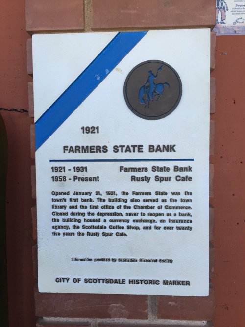 Plaque detailing the history of Farmers State Bank and Rusty Spur Cafe in Scottsdale, established in 1921.