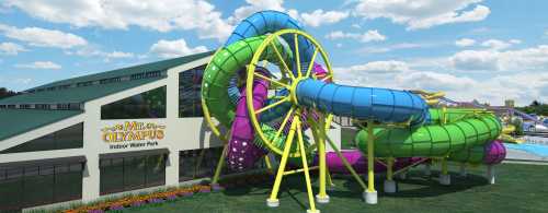 Colorful water slides twist and turn outside the Mt. Olympus Indoor Water Park under a blue sky with fluffy clouds.