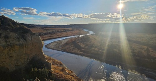 A spring hike in North Dakota with a view of a river weaving through the landscape.