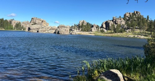 view of the rock formations and a small beach at sylvan lake, south dakota