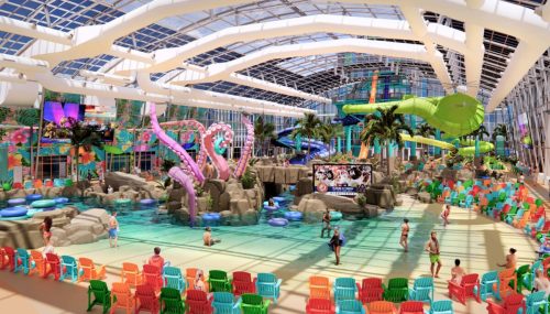 A vibrant indoor water park featuring colorful slides, a pool, and seating areas surrounded by tropical decor.