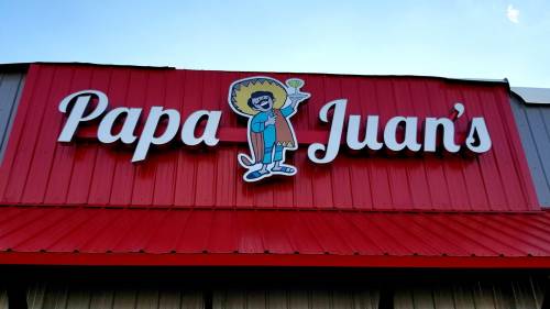 Sign for "Papa Juan's" featuring a cartoon character in a sombrero holding a drink, set against a red and gray background.