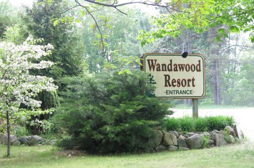 Sign for "Wandawood Resort" at the entrance, surrounded by greenery and trees.