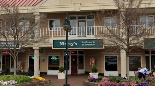 Exterior view of Nirsty's Ice Cream & Sandwiches, featuring a balcony and colorful planters outside.