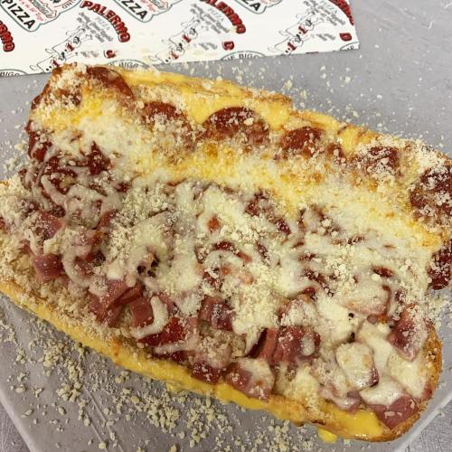 A cheesy sandwich filled with pepperoni and topped with grated cheese, served on a toasted bread.