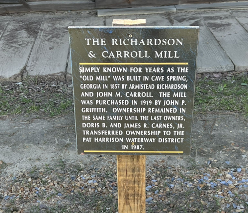 Sign detailing the history of the Richardson & Carroll Mill in Cave Spring, Georgia, built in 1857.