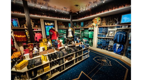 A vibrant merchandise store filled with themed clothing, accessories, and collectibles on display.