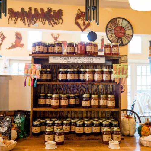 A wooden shelf displays jars of preserves and marmalades at the Catskill Mountain Country Store.