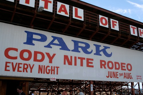 Sign for the Cody Nite Rodeo at the Park, featuring dates and details about the event.