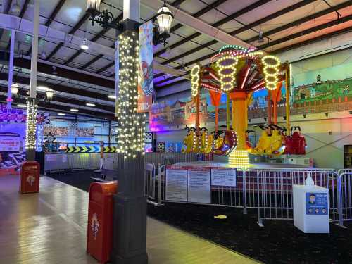 An indoor amusement park featuring colorful rides, bright lights, and festive decorations.