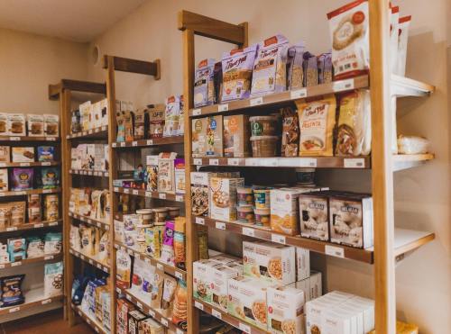 A well-organized grocery shelf displaying various packaged food items, including cereals, snacks, and spreads.