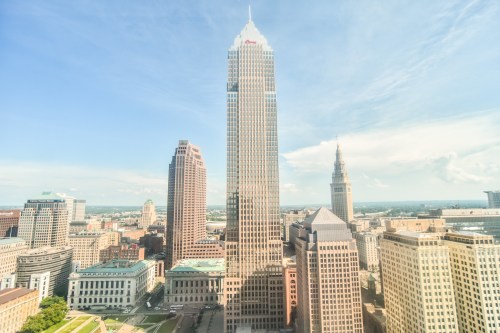 A skyline view of Cleveland featuring tall skyscrapers under a clear blue sky.