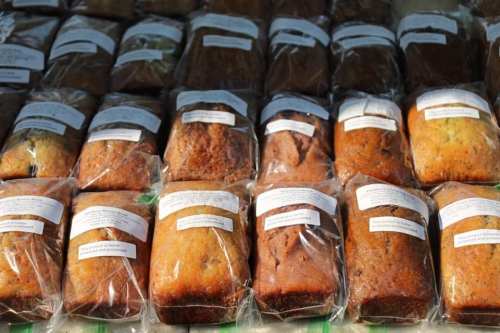 A variety of packaged baked goods lined up neatly, each with a label on top.