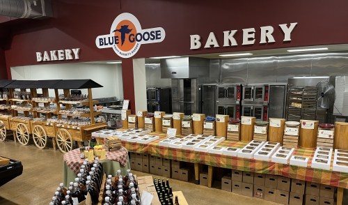Interior of Blue Goose Bakery featuring wooden displays, baked goods, and a warm, inviting atmosphere.