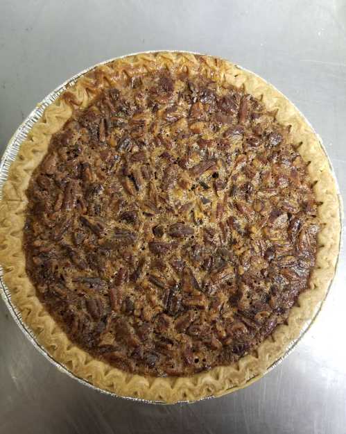 A freshly baked pecan pie with a golden crust and a rich, nutty filling.