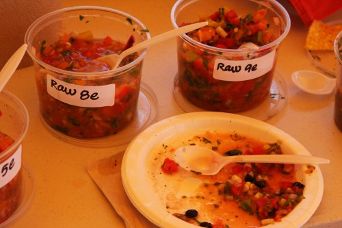 Two clear containers of salsa labeled "Raw Be" and "Raw 9e," with a messy plate and spoon nearby.