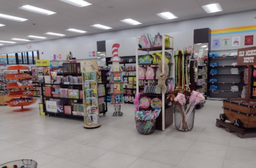A brightly lit store interior featuring shelves of toys, books, and colorful displays in a spacious layout.