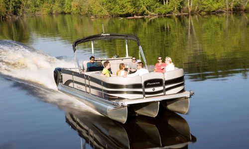 A group of people enjoying a pontoon boat ride on a calm river surrounded by lush greenery.