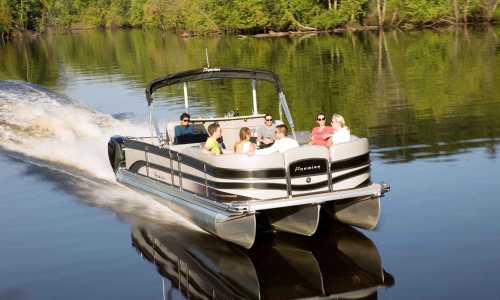 A group of people enjoying a pontoon boat ride on a calm river surrounded by lush greenery.