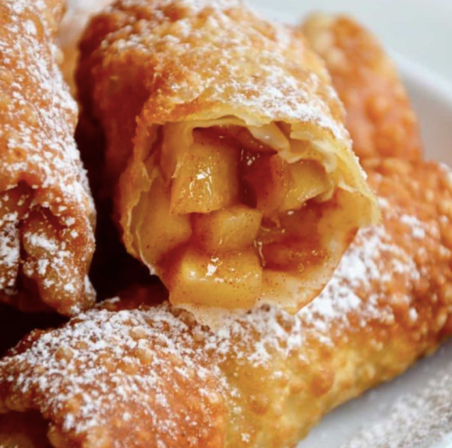 Crispy fried pastries filled with spiced apples and dusted with powdered sugar.