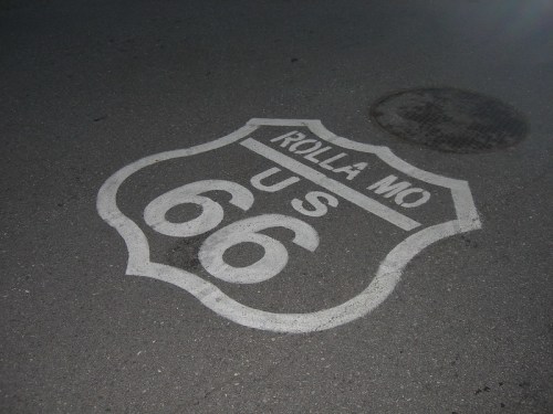 Sign for Route 66 in Rolla, Missouri, painted on the pavement at night.