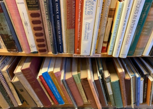 A close-up of a bookshelf filled with various books, showcasing colorful spines and diverse titles.