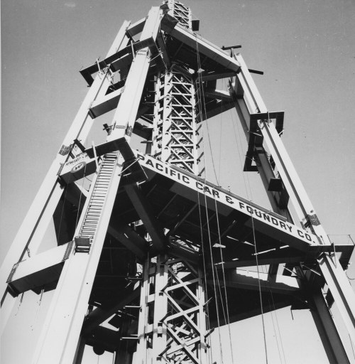 Black and white image of a tall industrial structure with "Pacific Car & Foundry Co." sign prominently displayed.