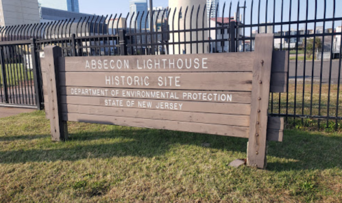 Sign for Absecon Lighthouse Historic Site, New Jersey, indicating it's managed by the Department of Environmental Protection.