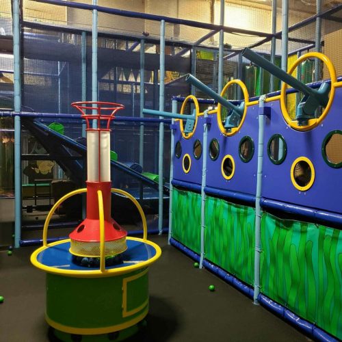 Colorful indoor playground with climbing structures, slides, and interactive features for children.