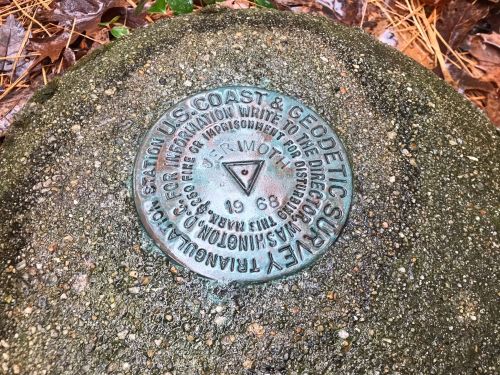 A metal survey marker embedded in concrete, labeled with "U.S. Coast & Geodetic Survey" and dated 1968.