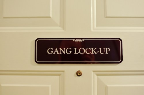 Sign on a door reading "GANG LOCK-UP," indicating a secure area.