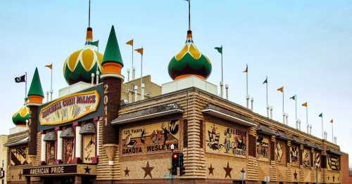 Colorful building with ornate turrets and flags, featuring murals celebrating American pride and local history.