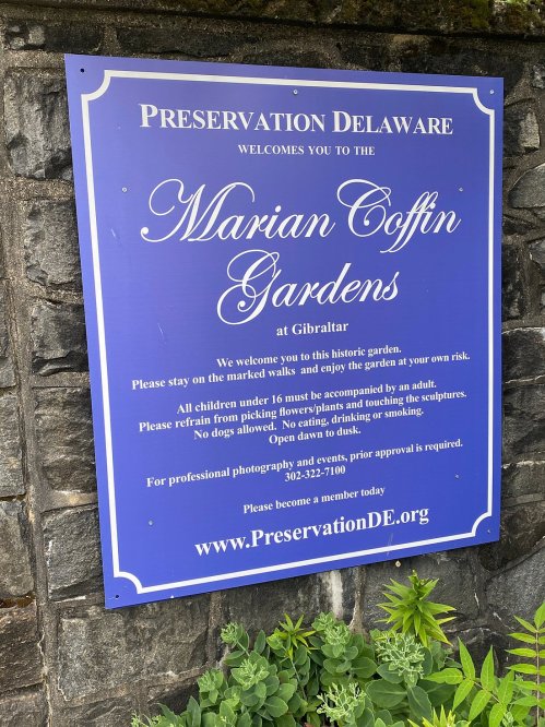 Sign welcoming visitors to the Marian Coffin Gardens, with guidelines for safety and photography.