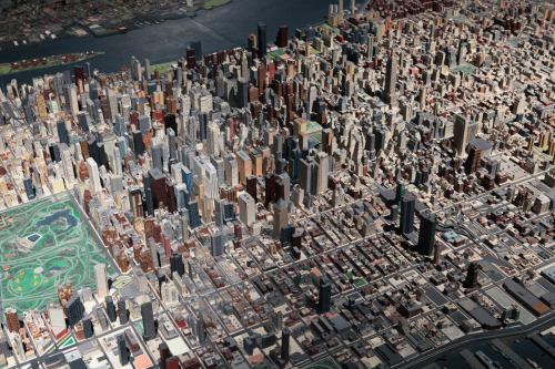 A detailed model of a cityscape, showcasing numerous buildings and streets from an aerial perspective.
