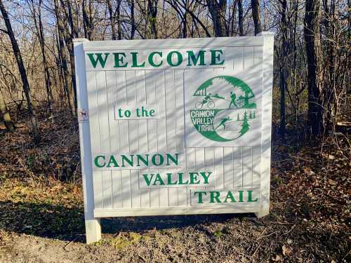 Sign welcoming visitors to the Cannon Valley Trail, featuring a logo with outdoor activities and nature elements.