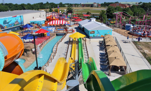 A vibrant water park featuring colorful slides, a lazy river, and various attractions under sunny skies.