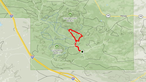Map showing a hiking trail in a mountainous area, marked in red, with elevation points and nearby roads.