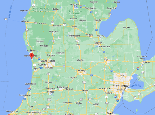 Map of Michigan highlighting Grand Rapids and nearby cities, with a red marker indicating the location of Grand Rapids.