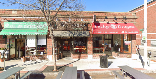 A street view of a brick building with three restaurants: Gail Ann Coffee, Victoria's, and Lucky Dragon.