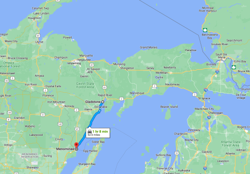 Map showing a route from Menominee to Gladstone, Michigan, with a travel time of 7 minutes.