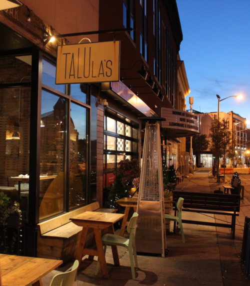 Exterior of Talula's restaurant at dusk, featuring outdoor seating and a warm, inviting atmosphere.
