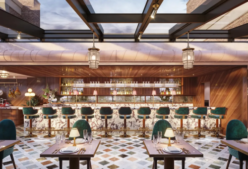 Elegant restaurant interior featuring a marble bar, green chairs, and a stylish, modern design with a glass ceiling.