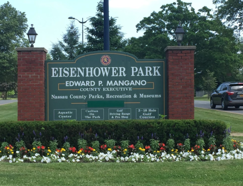 Sign for Eisenhower Park, featuring the name of the county executive and information about park facilities.