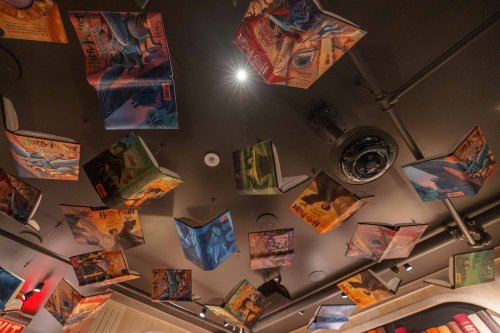 A ceiling adorned with floating, open Harry Potter book covers, creating a whimsical and magical atmosphere.