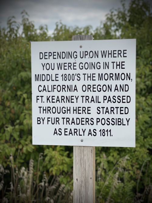 Sign detailing historical trails used by fur traders in the 1800s, including the Mormon, California, and Ft. Kearney trails.