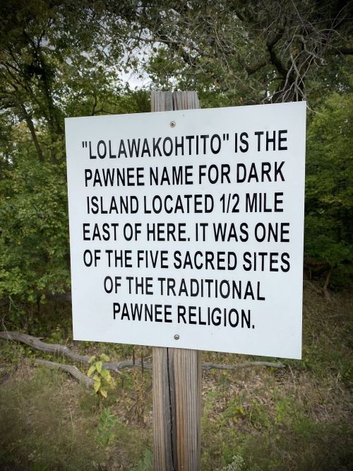 Sign explaining "Lolawakohtito," the Pawnee name for Dark Island, a sacred site in Pawnee religion, located east.