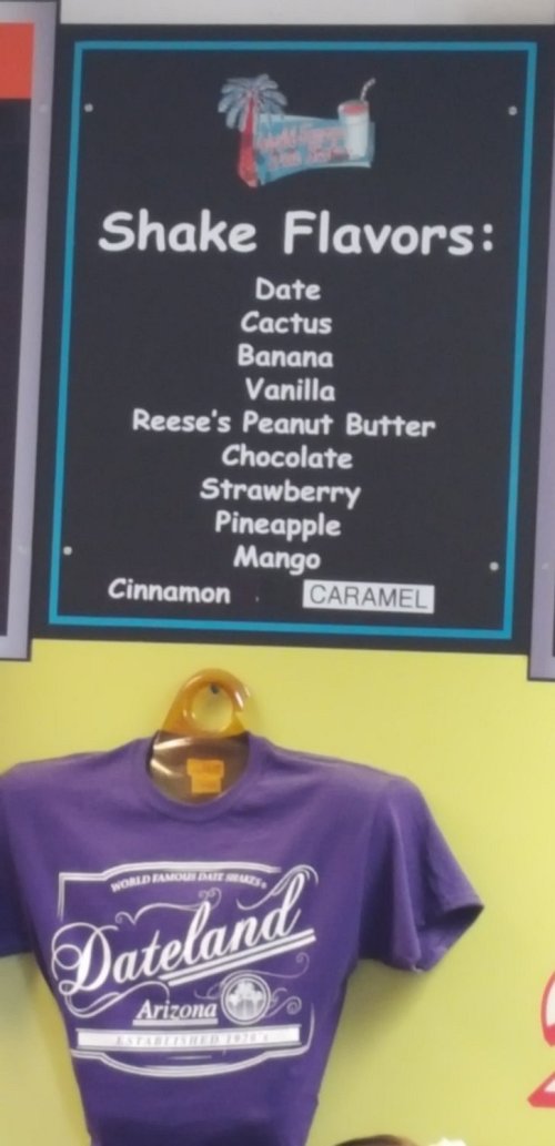 Menu board listing shake flavors: Date, Cactus, Banana, Vanilla, Reese's Peanut Butter, Chocolate, Strawberry, Pineapple, Mango.