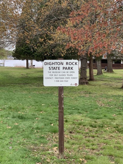 Sign for Dighton Rock State Park, indicating museum hours and contact information for guided tours.