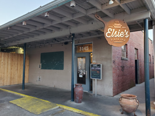 Exterior of Elsie's Plate & Pie restaurant, featuring a sign, entrance, and a chalkboard menu.