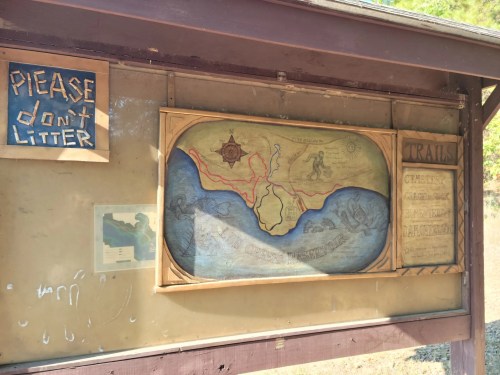 Map display at a trailhead with a "Please don't litter" sign above it.